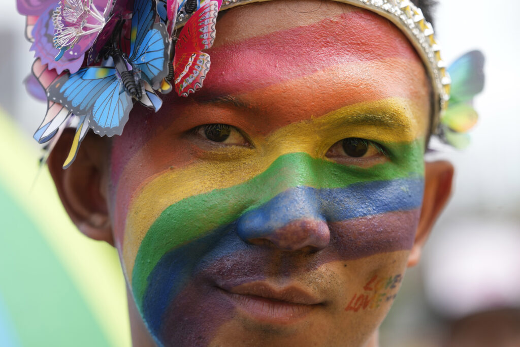 A participant with a rainbow painted on his face takes part in the Pride Parade in Bangkok, Thailand, Saturday, June 1, 2024. Thailand kicked off its celebration of the LGBTQ+ community's Pride Month with a parade on Saturday, as the country is on the course to become the first nation in Southeast Asia to legalize marriage equality. (AP Photo/Sakchai Lalit)
