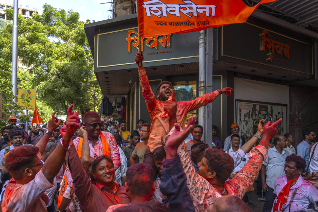 Supporters of Shiv Sena (Uddhav Balasaheb Thackeray) dance as they celebrate their party's lead during the counting of votes in India's national election in Mumbai, India, Tuesday, June 4, 2024. (AP Photo/Rafiq Maqbool)