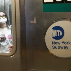 Commuters, one wearing a mask, ride the subway in New York, Friday, June 14, 2024. New York Gov. Kathy Hochul says she is considering a ban on face masks in the New York City subway system, following what she described as concerns over people shielding their identities while committing antisemitic acts. AP Photo/Seth Wenig