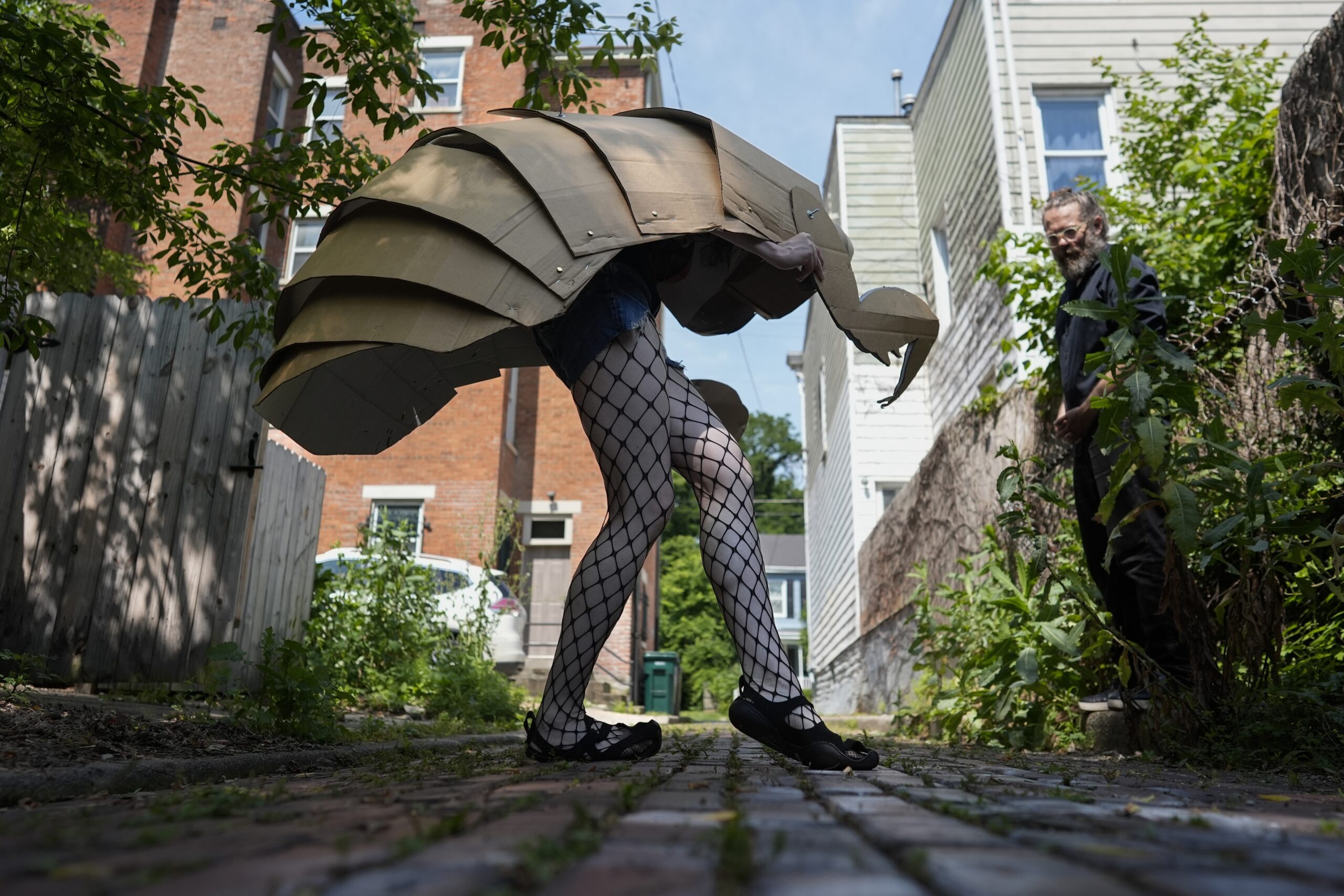 Renee Martin performs her cicada striptease in fishnet stockings and a cicada nymph puppet costume in a Cincinnati ally on Tuesday, June 4, 2024. The periodical cicadas that have blanketed parts of the American Midwest this spring are strange creatures, but they have nothing on some of their superfans. AP Photo/Carolyn Kaster