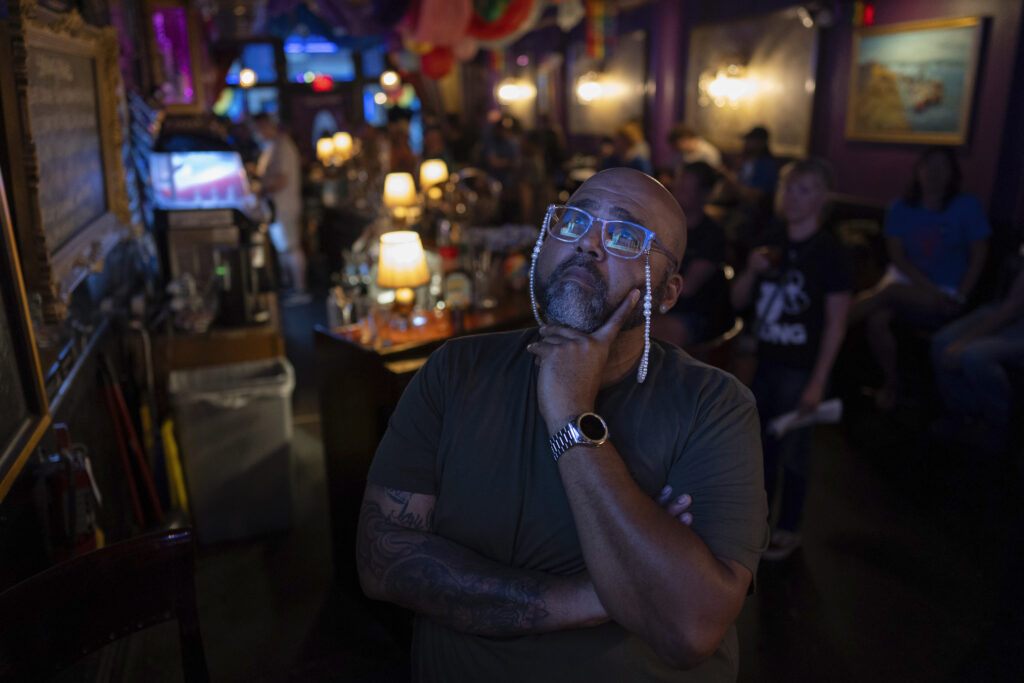 Jacardo Ralston, 47, from Pennsylvania, looks up to a television to watch the presidential debate between President Joe Biden and Republican presidential candidate former President Donald Trump at Tillie's Lounge on Thursday, June 27, 2024, in Cincinnati. (AP Photo/Carolyn Kaster)