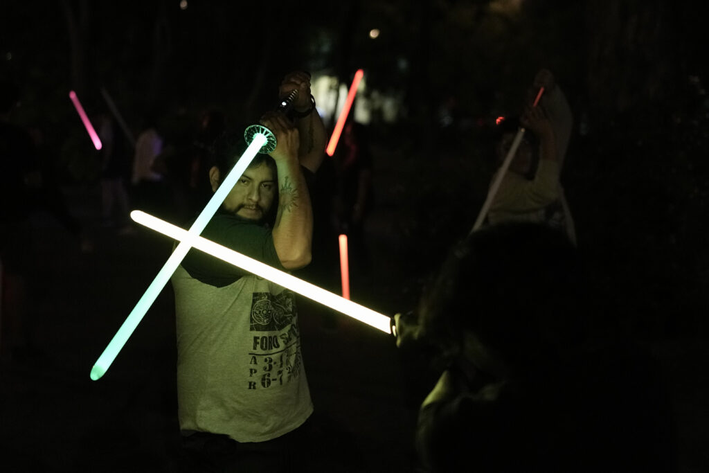 Students of the Jedi Knight Academy learn to use lightsabers at a park in Mexico City, late Saturday, June 15, 2024. The academy is a lightsaber combat and choreography school founded in 2019 and a dream come true for fans of Star Wars. (AP Photo/Eduardo Verdugo)