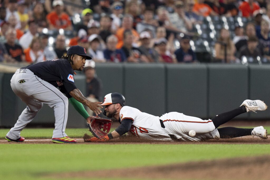 Baltimore Orioles' Colton Bowser, right, is safe at third base in front of Cleveland Guardians third baseman Jose Ramirez, left, during the sixth inning of a baseball game, Tuesday, June 25, 2024, in Baltimore. (AP Photo/Stephanie Scarbrough)