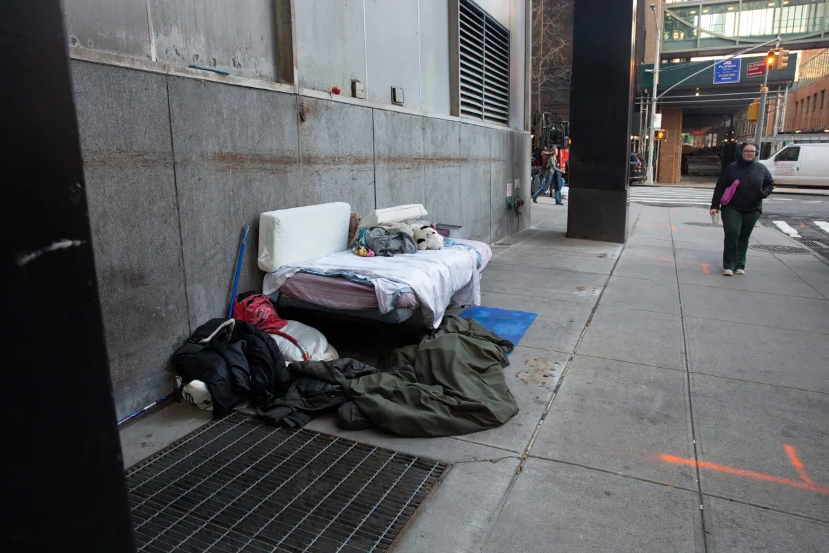 A homeless person created a make-shift sleeping area under an awning near the Dekalb Avenue station in Brooklyn, Jan. 8, 2024. Credit: Ben Fractenberg/THE CITY