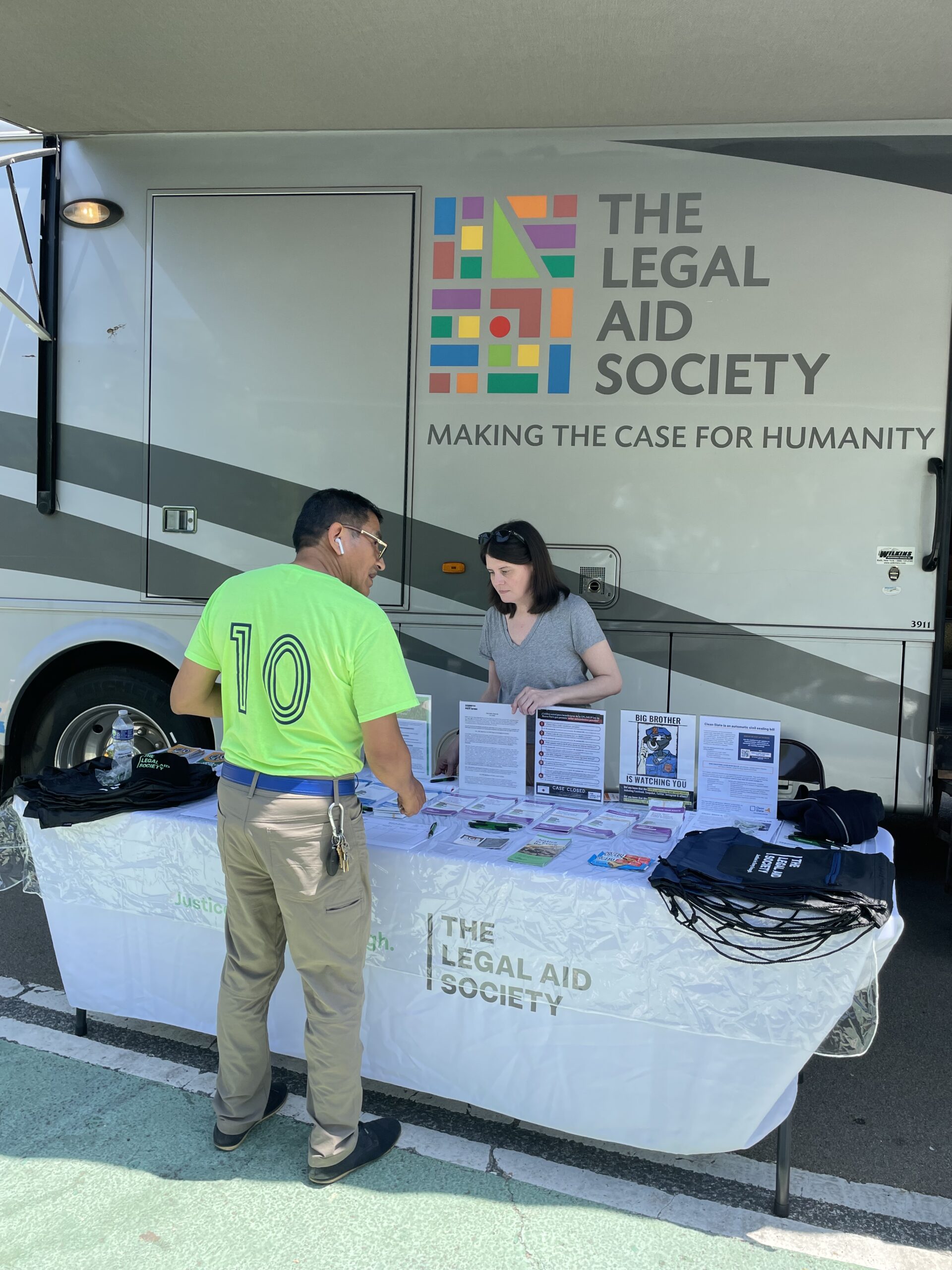 A resident consults with a legal advisor from the Justice Bus during its stop in Brooklyn as part of the Legal Aid Society’s initiative to provide free legal resources to NYCHA residents. Photo courtesy of Legal Aid NYC