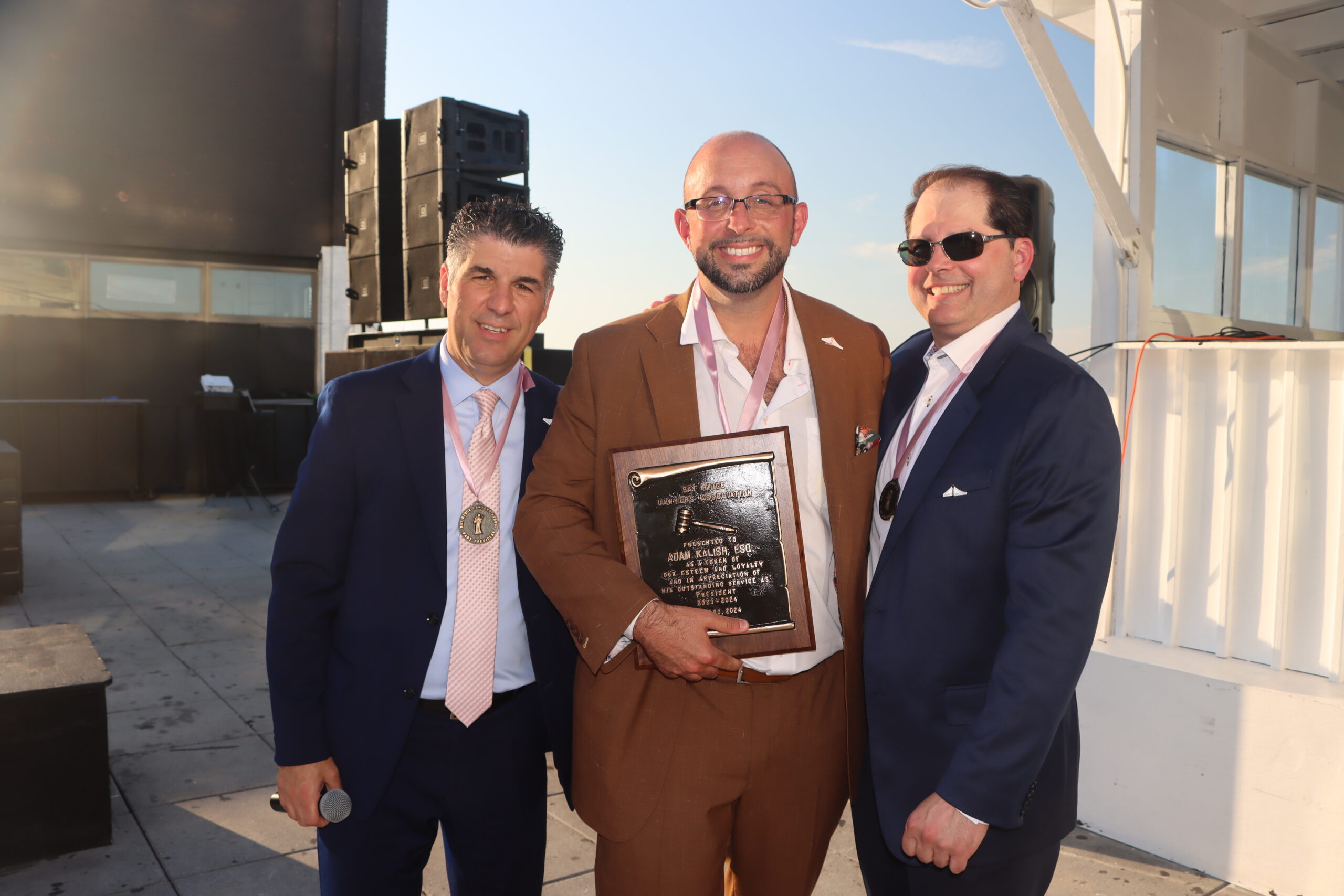 Dominic Famulari (left) and Steven Chiaino (right) present outgoing BRLA President Adam Kalish with a plaque in recognition of his outstanding service. Eagle photos by Mario Belluomo