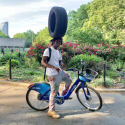 You may have seen Brooklyn stuntman Leh-Boy cycling around while balancing a variety of strange objects on his head. He recently spoke to the Brooklyn Eagle in Cadman Plaza Park. Photo: Mary Frost, Brooklyn Eagle