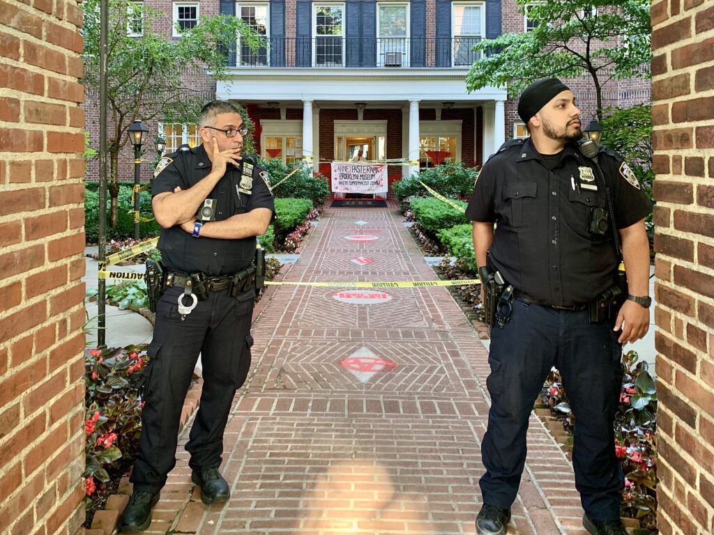 Police from the 84th Precinct blocked off the front of the Mansion House co-op building on Hicks Street with crime scene tape and stood guard at the entrance. Photo: Mary Frost, Brooklyn Eagle