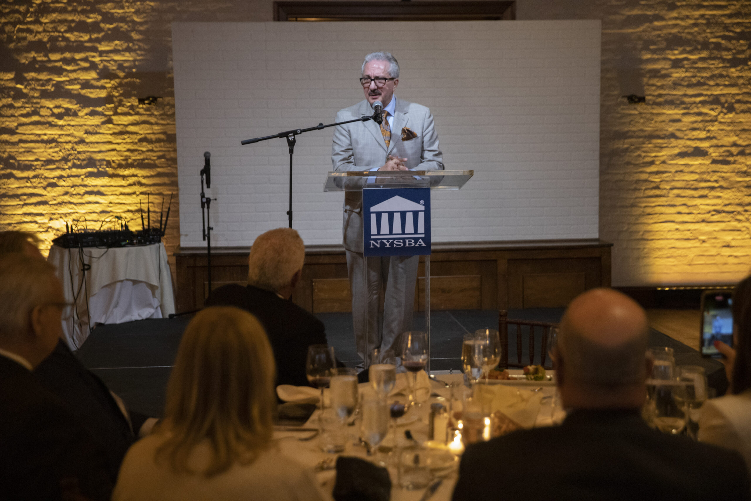 Domenick Napoletano, newly installed as the 127th president of the New York State Bar Association, addresses attendees at the Liberty Warehouse in Red Hook, Brooklyn. Eagle photos by John McCarten