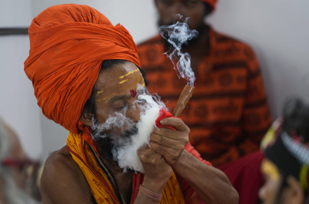 A Hindu holy man smokes as he waits in Jammu, India, to register for the annual pilgrimage to the Amarnath cave shrine, Thursday, June 27, 2024. The pilgrimage held annually to the holy Amarnath cave, dedicated to Hindu god Shiva is scheduled to start on June 29 this year. (AP Photo/Channi Anand)