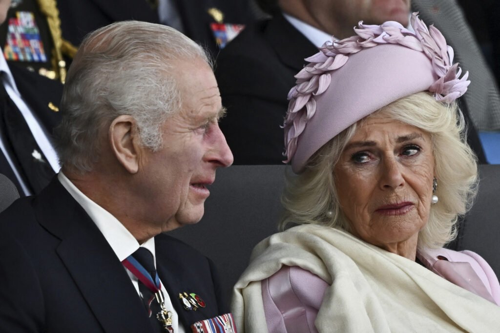 Britain's King Charles and Queen Camilla react as they attend a commemorative event for the 80th anniversary of D-Day, in Portsmouth, England, Wednesday June 5, 2024. (Dylan Martinez/Pool via AP)