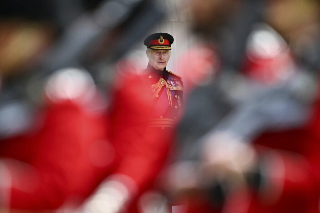 Britain's King Charles III reviews the Irish Guards, during a ceremony where he presents New Colours to No 9 and No 12 Company of the Irish Guards, at Windsor Castle, Windsor, England, Monday, June 10, 2024. The new Colours will be those trooped in the Trooping of the Colour at His Majesty's official Birthday Parade in London on Saturday June 15, 2024. (Ben Stansall/Pool Photo via AP)