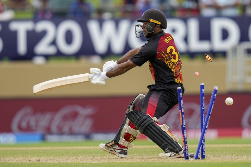 Papua New Guinea's Sese Bau is bowled by West Indies' Alzarri Joseph during an ICC Men's T20 World Cup cricket match at Guyana National Stadium in Providence, Guyana, Sunday, June 2, 2024. (AP Photo/Ramon Espinosa)