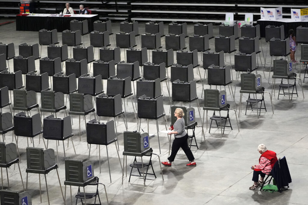 A voter has dozens of booths to choose from as she prepares to cast her ballot in Maine's primary election, Tuesday, June 11, 2024, in Bangor, Maine. (AP Photo/Robert F. Bukaty)