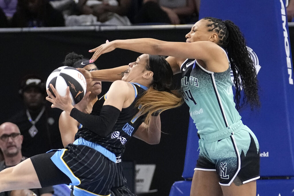 Chicago Sky's Chennedy Carter, left, steals the ball from New York Liberty's Betnijah Laney-Hamilton during the first half of a WNBA basketball game Tuesday, June 4, 2024, in Chicago. (AP Photo/Charles Rex Arbogast)