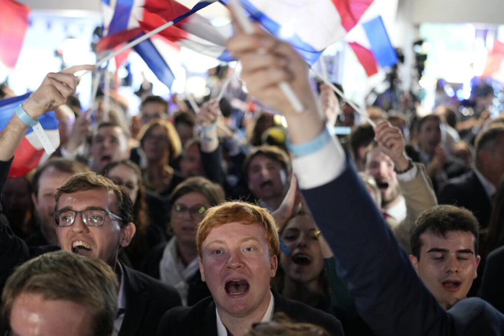 Supporters of French far-right National Rally react at the party election night headquarters, Sunday, June 9, 2024 in Paris. First projected results from France put far-right National Rally party well ahead in EU elections, according to French opinion poll institutes. (AP Photo/Lewis Joly)