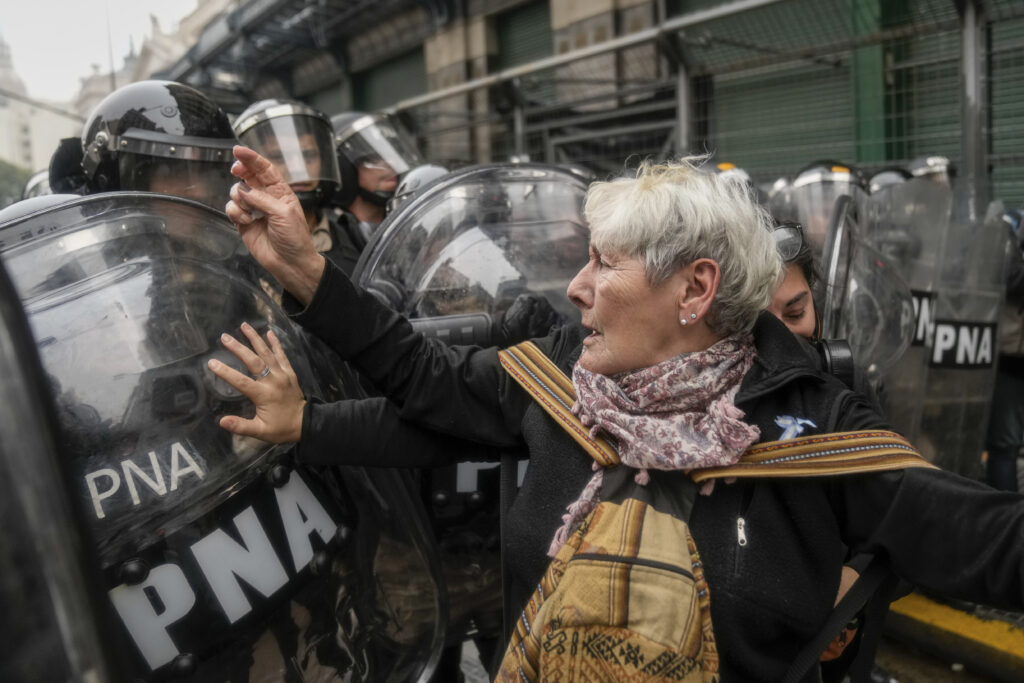 Anti-government protesters challenge police outside Congress where lawmakers debate a reform bill promoted by Argentine President Javier Milei in Buenos Aires, Argentina, Wednesday, June 12, 2024. (AP Photo/Rodrigo Abd)