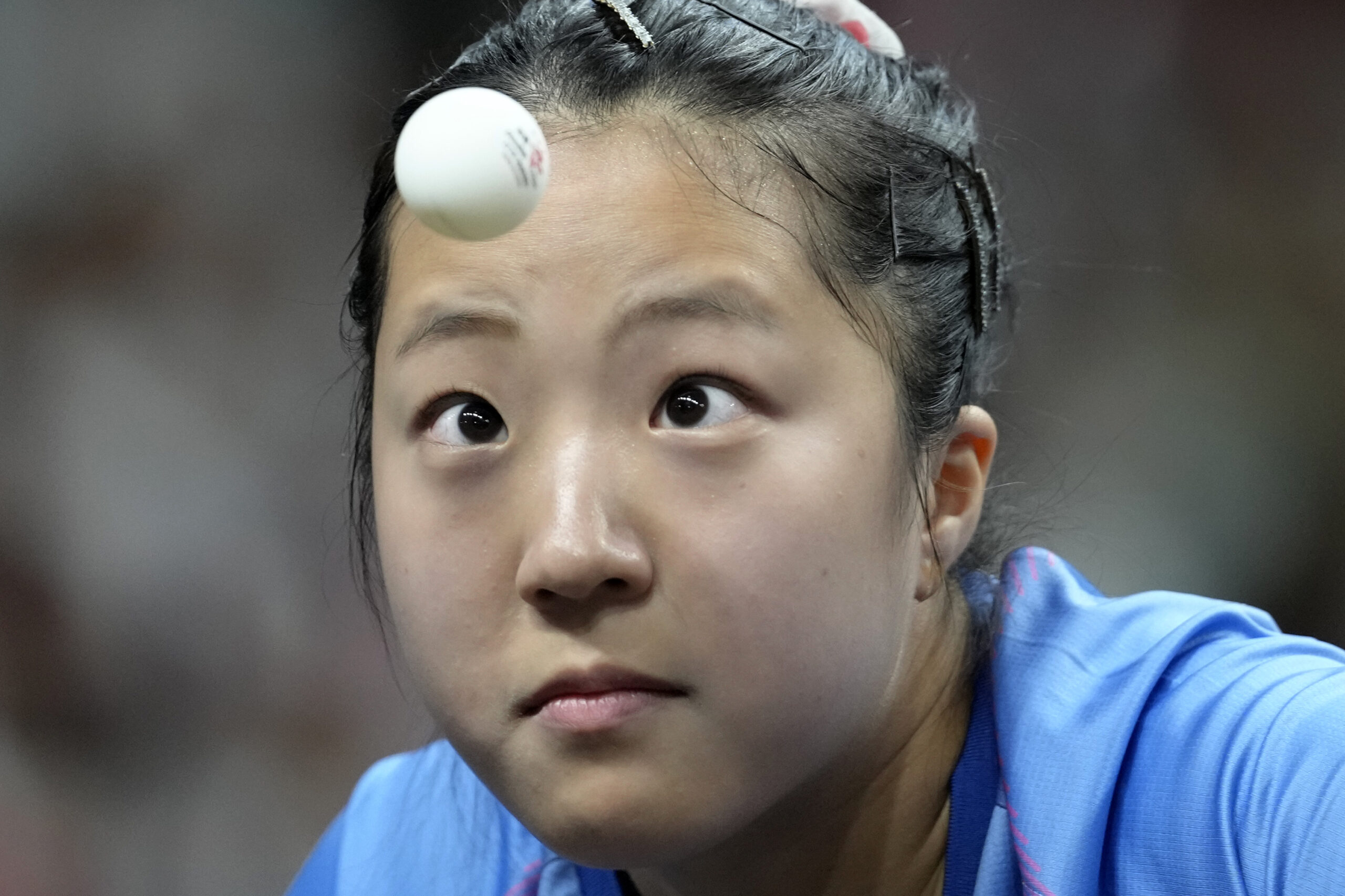 South Korea's Shin Yubin watches the ball during a mixed doubles semifinal table tennis game against China's Wang Chuqin and Sun Yingsha, at the 2024 Summer Olympics, Monday, July 29, 2024, in Paris, France. (AP Photo/Petros Giannakouris)