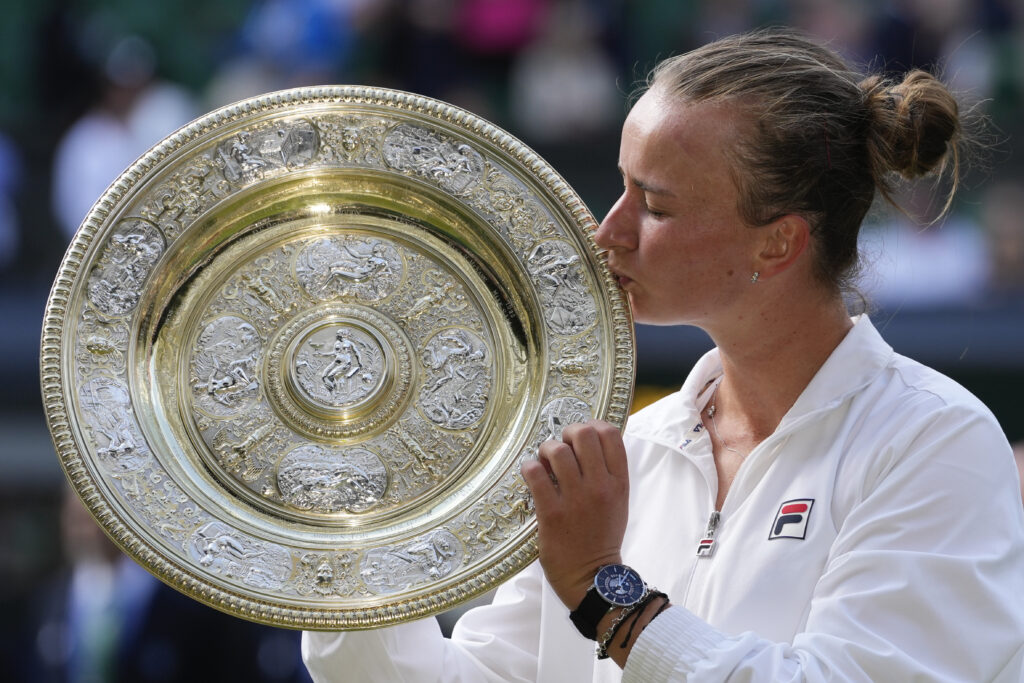 Barbora Krejcikova of the Czech Republic kisses her trophy after defeating Jasmine Paolini of Italy in the women's singles final of the Wimbledon tennis championships in London, Saturday, July 13, 2024. (AP Photo/Kirsty Wigglesworth)