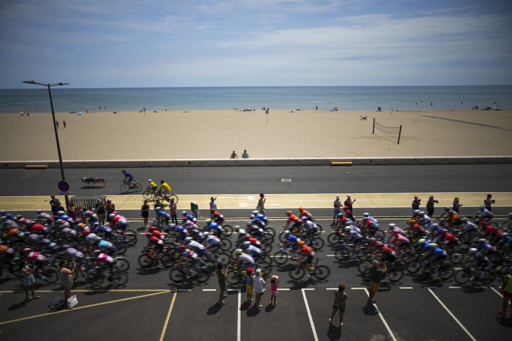 The pack rides the ceremonial parade along the Mediterranean Sea in Gruissan during the sixteenth stage of the Tour de France cycling race over 188.6 kilometers (117.2 miles) starting in Gruissan and finishing in Nimes, France, Tuesday, July 16, 2024. (AP Photo/Daniel Cole)