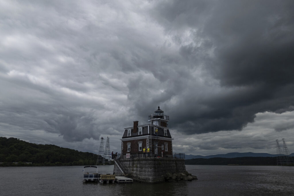 Larry Gaylord, DJ Dorbert and Chad Frederick work on the Hudson-Athens Lighthouse, Wednesday, June 12, 2024, in Hudson, N.Y. (AP Photo/Julia Nikhinson)