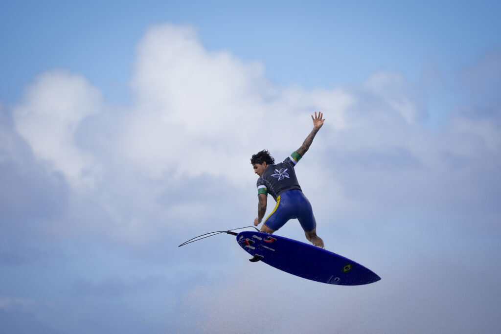 Gabriel Medina, of Brazil, performs an aerial move as he surfs during a training day ahead the 2024 Summer Olympics surfing competition Wednesday, July 24, 2024, in Teahupo'o, Tahiti. (AP Photo/Gregory Bull)