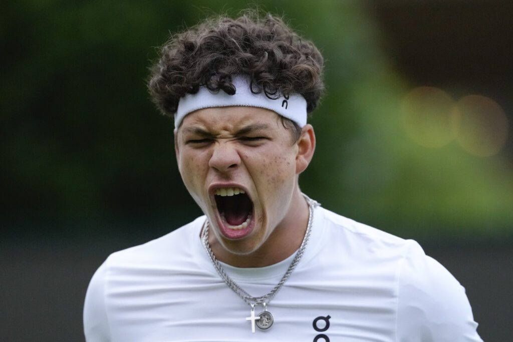 Ben Shelton of the United States reacts during his first round match against Mattia Bellucci of Italy at the Wimbledon tennis championships in London, Monday, July 1, 2024. (AP Photo/Kirsty Wigglesworth)