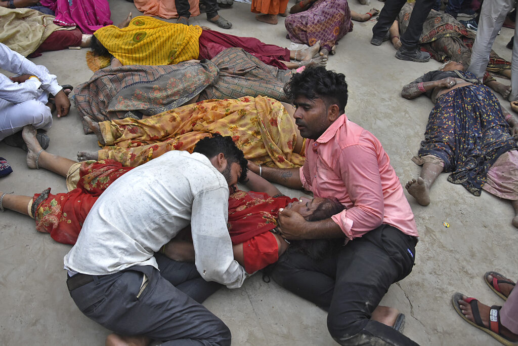 People mourn next to the bodies of their relatives outside the Sikandrarao hospital in Hathras district about 350 kilometers (217 miles) southwest of Lucknow, India, Tuesday, July 2, 2024. A stampede among thousands of people at a religious gathering in northern India killed at least 60 and left scores injured, officials said Tuesday, adding that many women and children were among the dead and the toll could rise. (AP Photo)