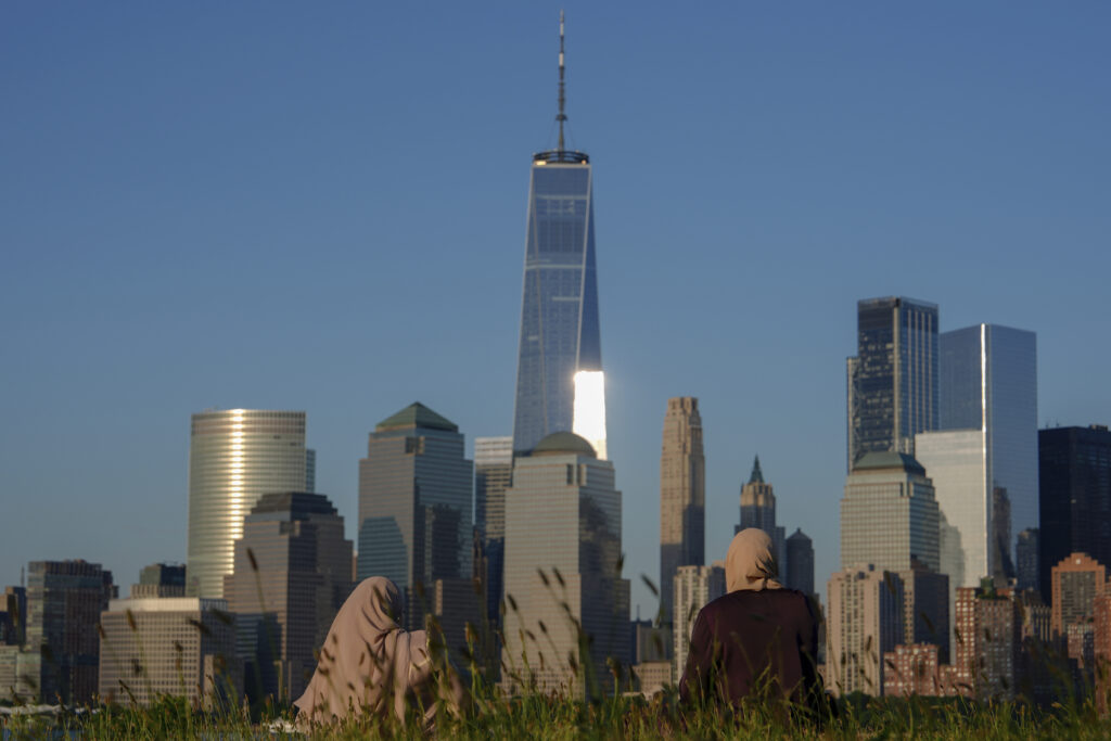 People look out at the New York City skyline at sunset, Sunday, June 16, 2024, in Jersey City, N.J. AP Photo/Julia Nikhinson, File