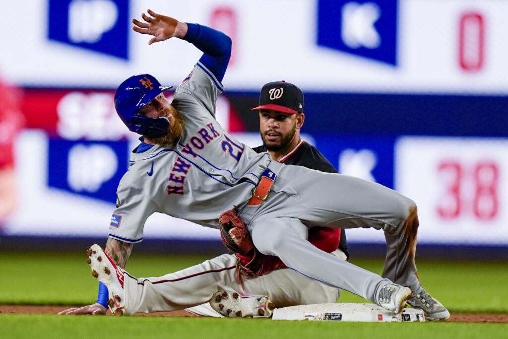 New York Mets' Ben Gamel, left, is safe at second base on the steal as he falls over onto Washington Nationals second baseman Ildemaro Vargas during the 10th inning of a baseball game at Nationals Park, Tuesday, July 2, 2024, in Washington. The Mets won 7-2 in 10 innings. (AP Photo/Alex Brandon)