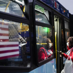 In this Oct. 22, 2020, file photo, passengers board a bus near the Fordham Metro North station, in New York. AP Photo/Frank Franklin II, File