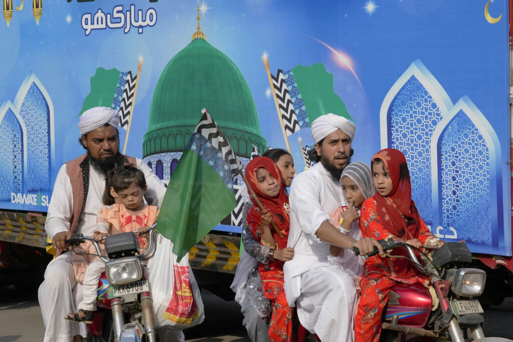 Supporters of a religious group 'Dawat-e-Islami with their children take part in a rally for Mawlid al-Nabi holiday celebrating the birthday of Islam's prophet, Muhammad, born in the year 570, in Lahore, Pakistan, Tuesday, Sept. 17, 2024. (AP Photo/K.M. Chaudary)