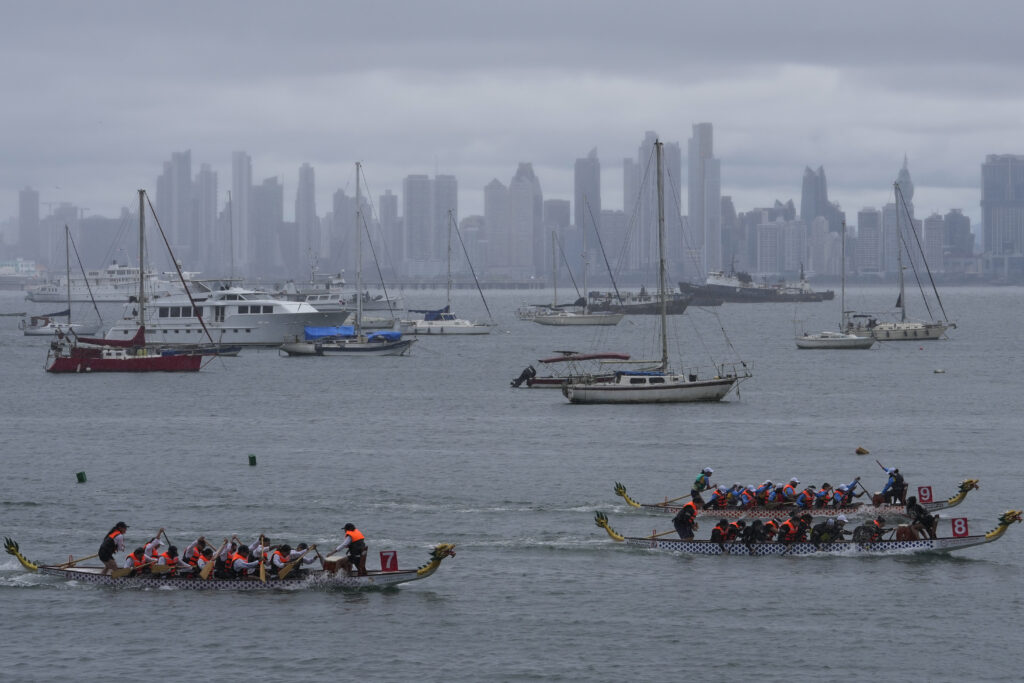 People race in boats shaped like Chinese dragons in an event organized by the Chinese community, in Amador Causeway, Panama City, Sunday, Sept. 29, 2024. (AP Photo/Matias Delacroix)