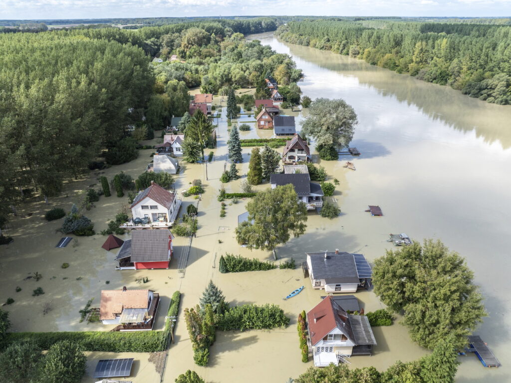 An aerial picture taken with a drone shows the flooded resort village of Venek and the swollen Danube River near Gyor, Hungary, Tuesday, September 17, 2024. (Gergely Janossy/MTI via AP)