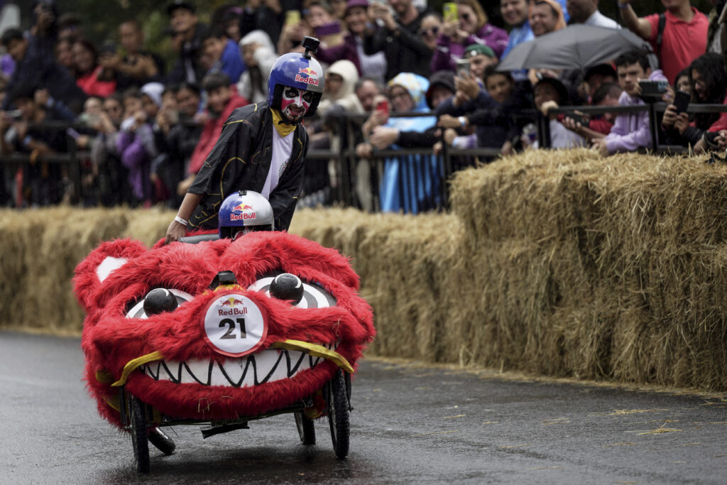 Participants complete a homemade gravity-powered vehicles race in Bogota, Colombia, Sunday, Sept. 29, 2024. (AP Photo/Ivan Valencia)