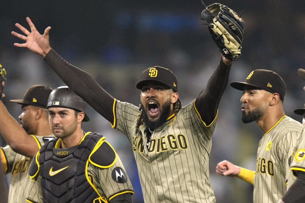 San Diego Padres' Fernando Tatis Jr., center, celebrates with teammates after the Padres clinched a playoff spot with a triple play to end their baseball game against the Los Angeles Dodgers, Tuesday, Sept. 24, 2024, in Los Angeles. (AP Photo/Mark J. Terrill)