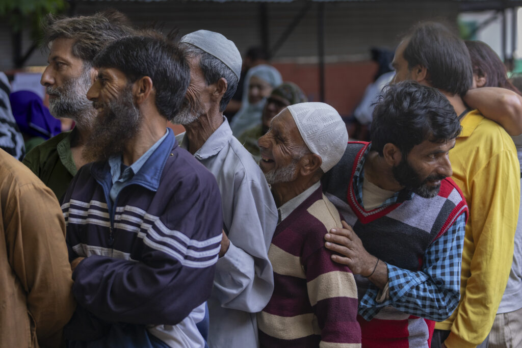 People queue up at a polling booth to cast their vote in Naira, south of Srinagar, Indian controlled Kashmir, Wednesday, Sept. 18, 2024. (AP Photo/Dar Yasin)