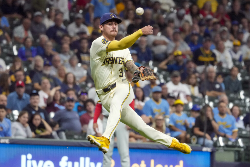 Milwaukee Brewers' Joey Ortiz tries to make a play on a ball hit by Philadelphia Phillies' Kyle Schwarber during the sixth inning of a baseball game Tuesday, Sept. 17, 2024, in Milwaukee. (AP Photo/Morry Gash)