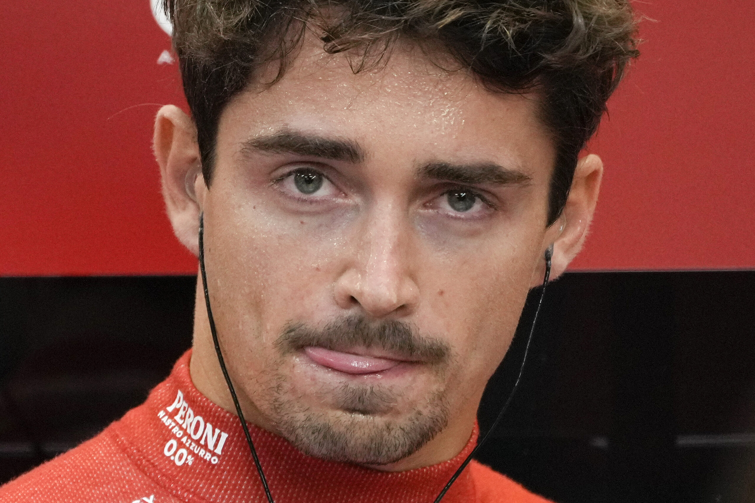 Ferrari driver Charles Leclerc of Monaco waits inside their garage during the second practice session of the Singapore Formula One Grand Prix at the Marina Bay Street Circuit, in Singapore, Friday, Sept. 20, 2024. (AP Photo/Vincent Thian)