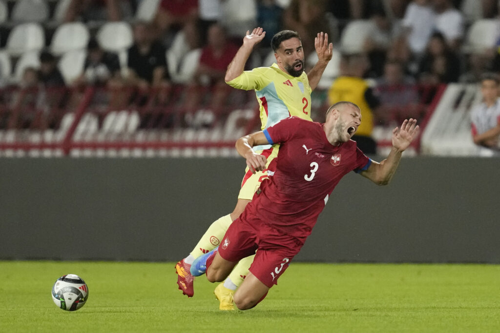 Spain's Dani Carvajal, left, fouls Serbia's Strahinja Pavlovic during the UEFA Nations League soccer match between Serbia and Spain at the Rajko Mitic Stadium, in Belgrade, Serbia, Thursday, Sept. 5, 2024. (AP Photo/Darko Vojinovic)