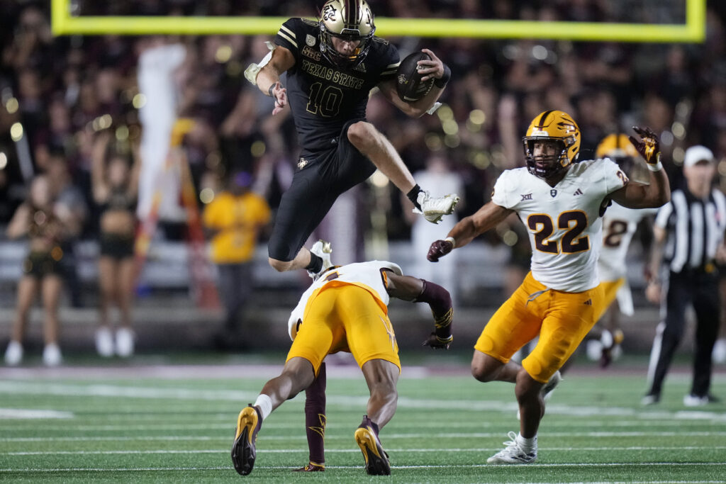 Texas State wide receiver Joey Hobert (10) leaps over Arizona State defensive back Myles Rowser (4) during the second half of an NCAA college football game in San Marcos, Texas, Thursday, Sept. 12, 2024. (AP Photo/Eric Gay)