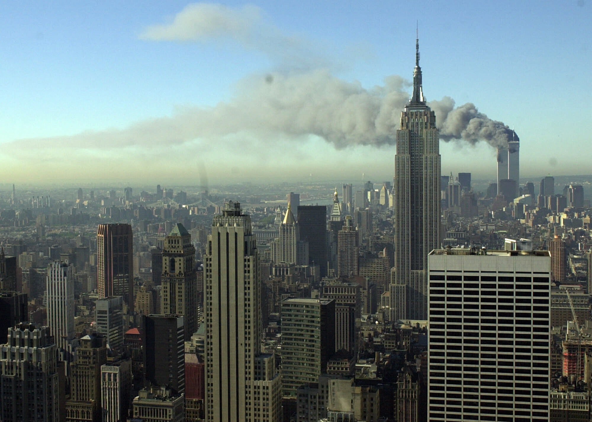 Smoke billows across the New York City skyline after two hijacked planes crashed into the twin towers on Sept. 11, 2001. Most Americans were guided through the events of the day by one of three men: Tom Brokaw of NBC News, Peter Jennings of ABC and Dan Rather of CBS. Each had extensive reporting experience before that, Brokaw and Rather were at the White House during Watergate, and Jennings has been a foreign correspondent. AP Photo/Patrick Sison, File