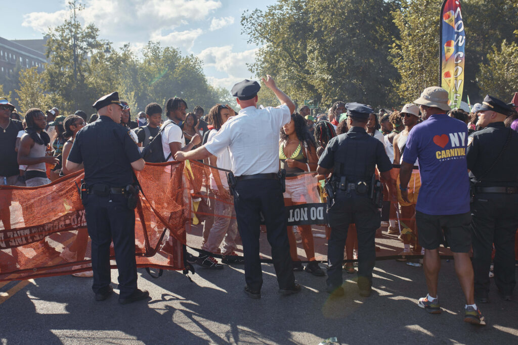 Police move revelers from the street after a shooting on Eastern Parkway, near the corner of Franklin Avenue, during the West Indian Day Parade on Monday, Sept. 2, 2024, in the Brooklyn borough of New York.