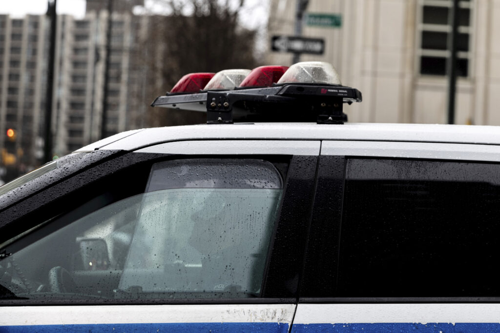 A police officer sits in a car near the Brooklyn Bridge, Dec. 16, 2022 in Brooklyn. AP Photo/Julia Nikhinson, file