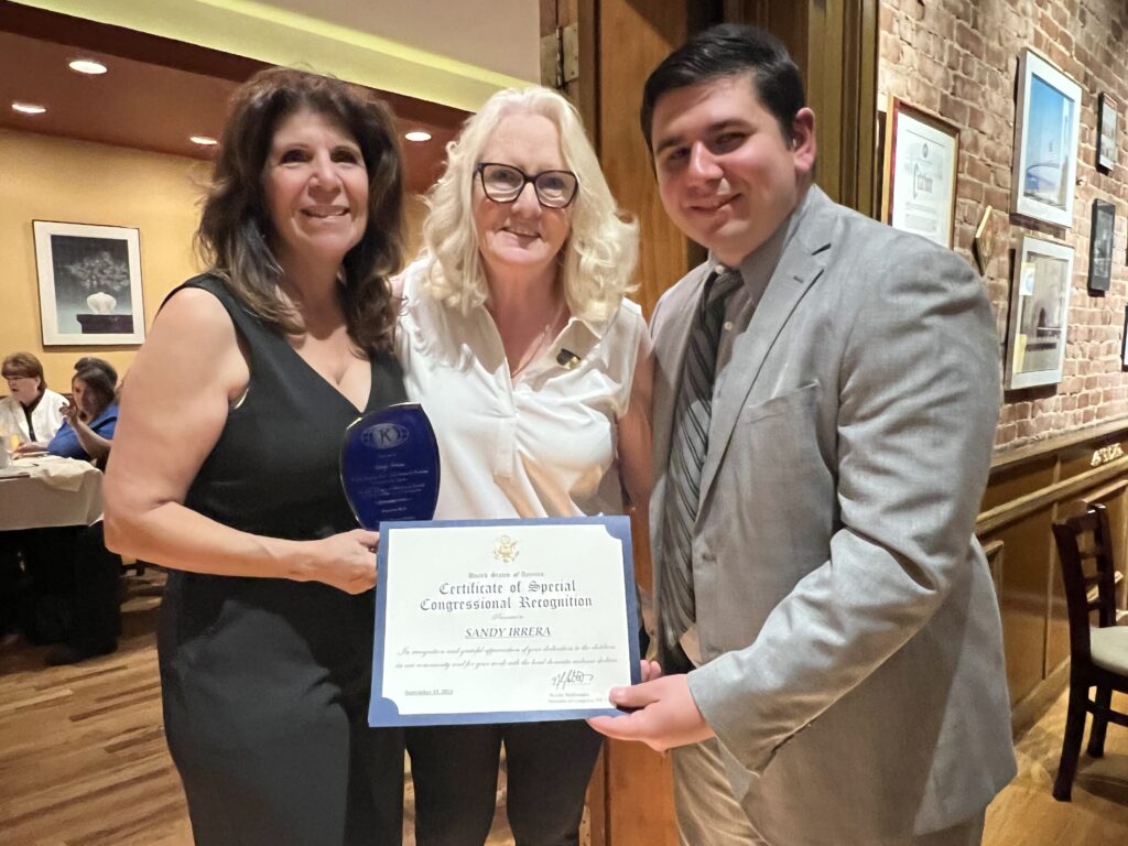 Sandy Irrera presented with a “Certificate of Special Congressional Recognition” award. Photo by Wayne Daren Schneiderman