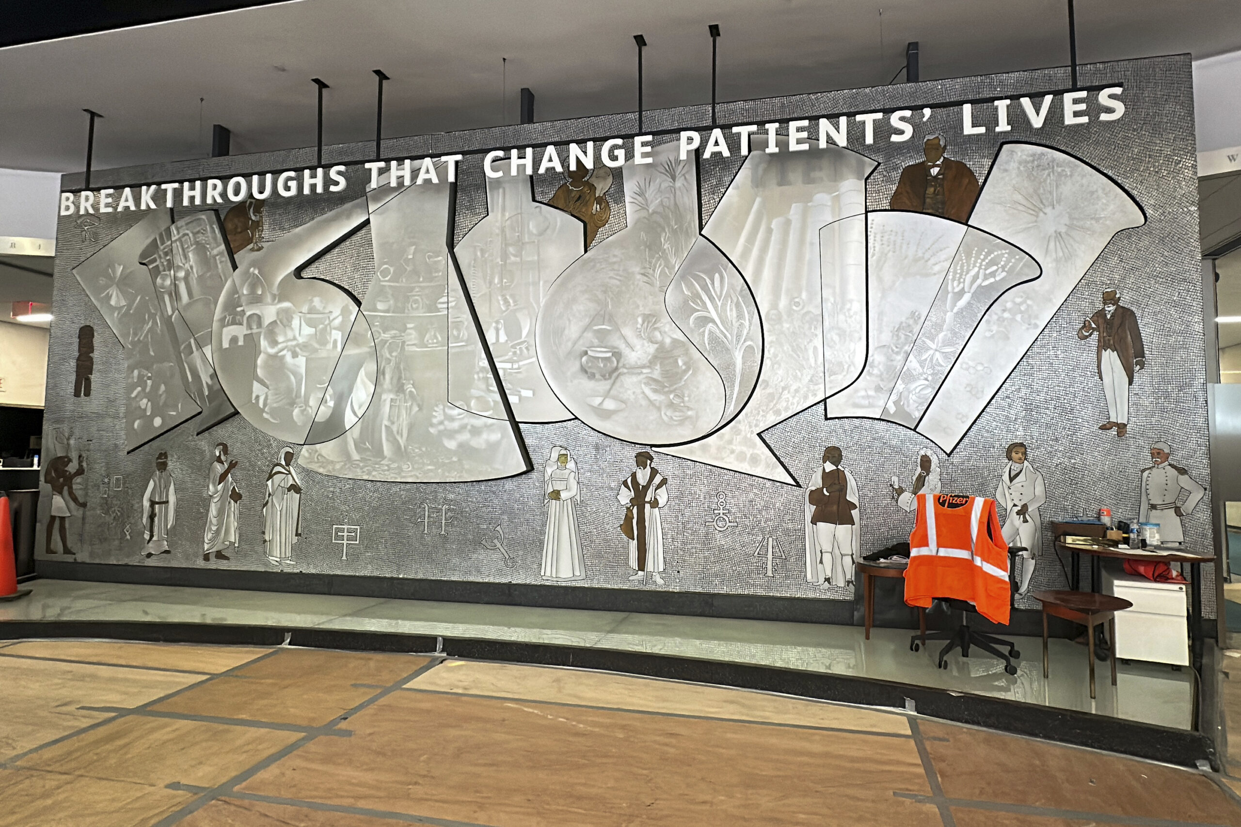 A metal mosaic mural created in 1960 by Greek-born artist Nikos Bel-Jon and titled "Medical Research Through the Ages" is in the lobby of the old Pfizer headquarters in New York on Thursday, August 29, 2024. AP Photo/Ted Shaffrey