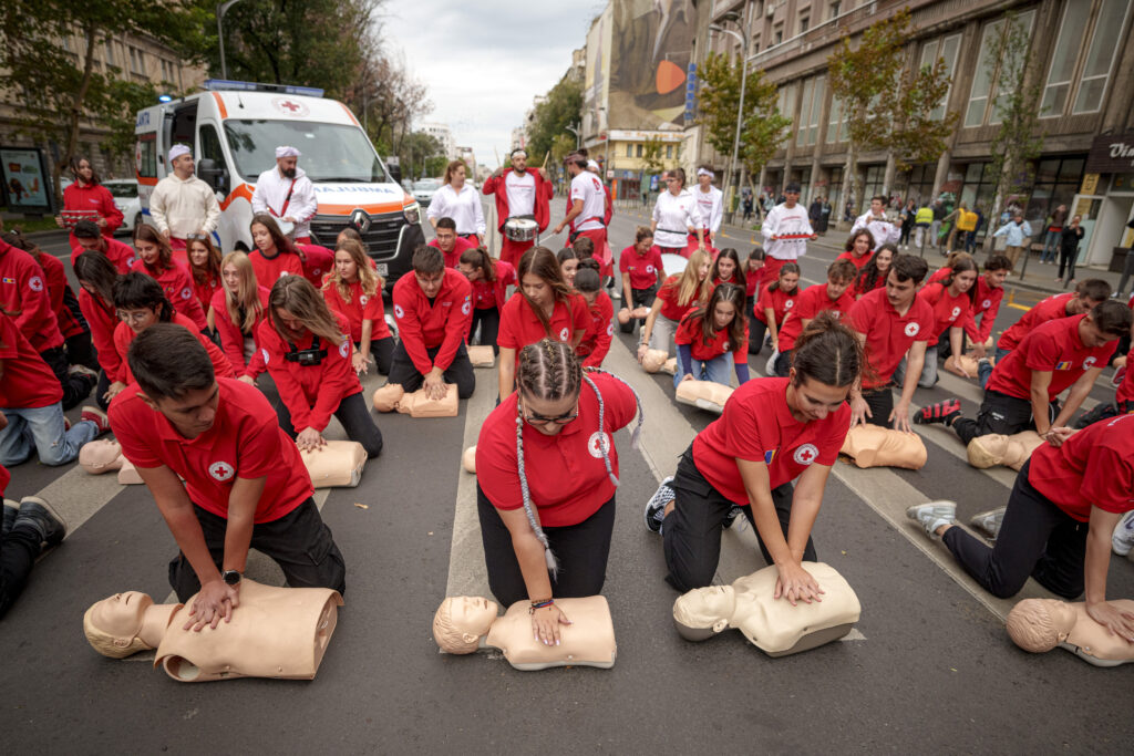 Romanian Red Cross volunteers perform resuscitation on mannequins during a flash mob to mark the World Restart a Heart Day in Bucharest, Romania, Wednesday, Oct. 16, 2024. (AP Photo/ Andreea Alexandru)