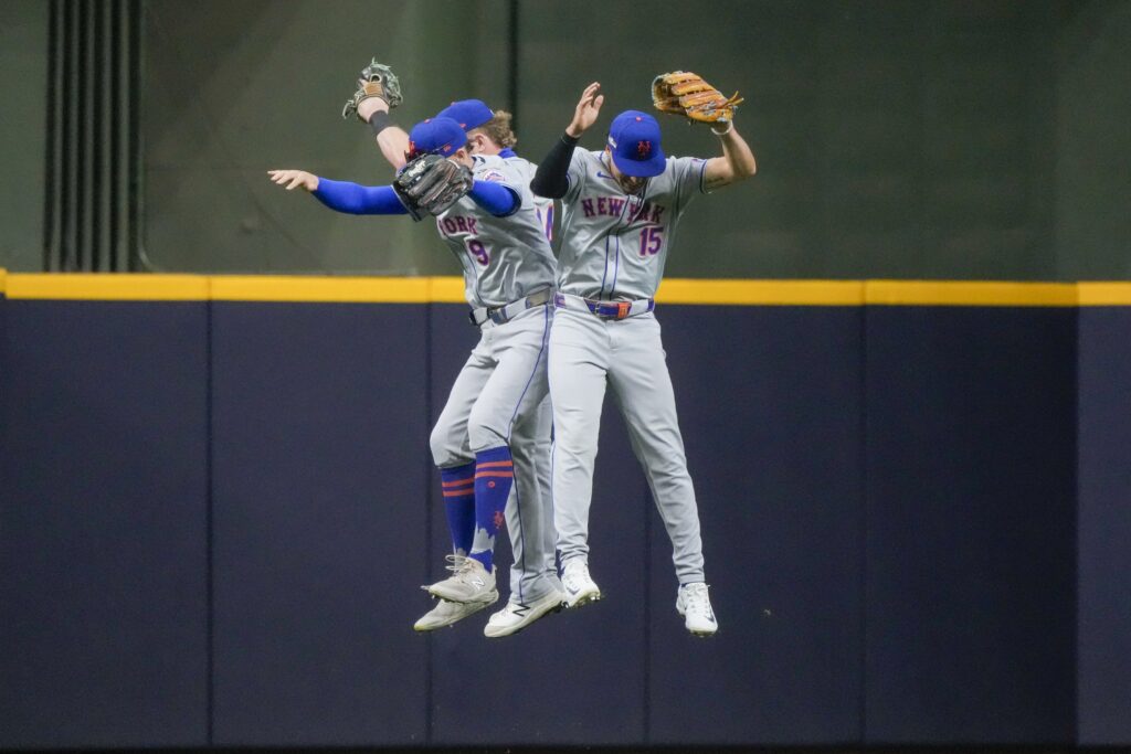 New York Mets' Brandon Nimmo, Harrison Bader, and Tyrone Taylor celebrate after Game 2 of a National League wild card baseball game against the Milwaukee Brewers Tuesday, Oct. 1, 2024, in Milwaukee. The Mets won 8-4. (AP Photo/Morry Gash)