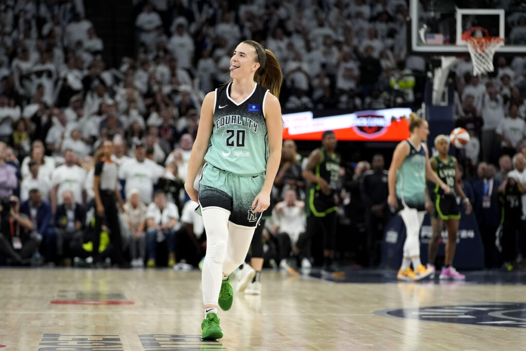 New York Liberty guard Sabrina Ionescu celebrates after making a 3-point basket during the second half against the Minnesota Lynx in Game 3 of a WNBA basketball final playoff series, Wednesday, Oct. 16, 2024, in Minneapolis. The Liberty won 80-77. (AP Photo/Abbie Parr)