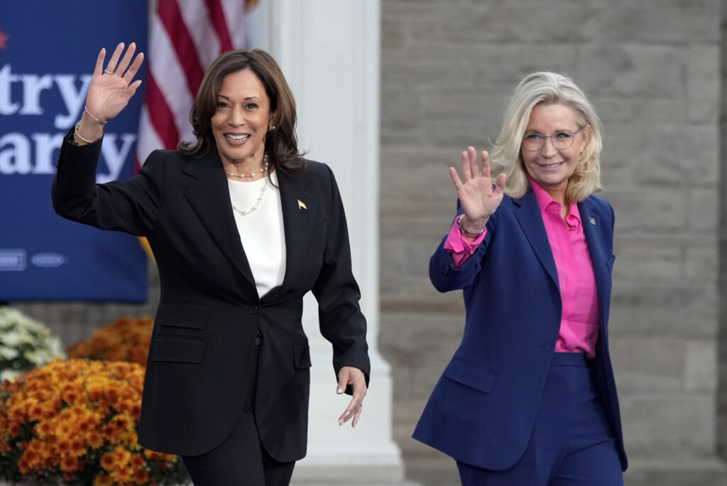 Democratic presidential nominee Vice President Kamala Harris walks with former Rep. Liz Cheney, R-Wyo., at a campaign rally at Ripon College, Thursday, Oct. 3, 2024, in Ripon, Wis. (AP Photo/Charlie Neibergall)